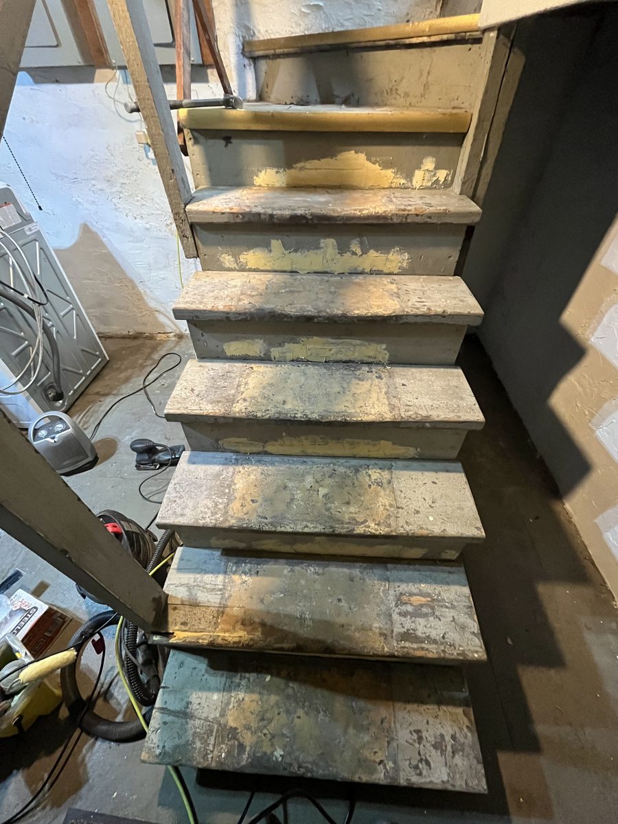 Basement stairs before restoration dangerous peeling paint Saint Paul - JAM Custom Carpentry