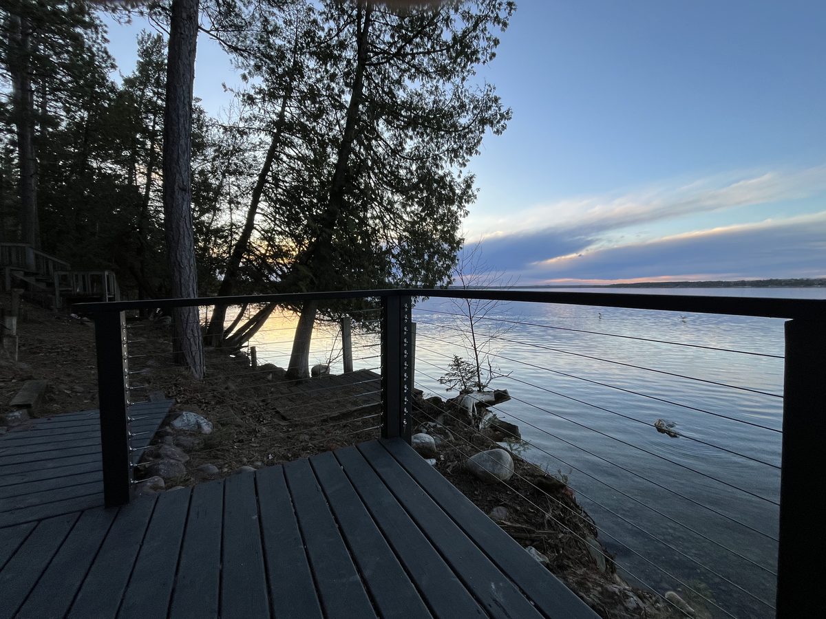 Cable railing lakeside deck sunset Minnesota lake cabin - JAM Custom Carpentry