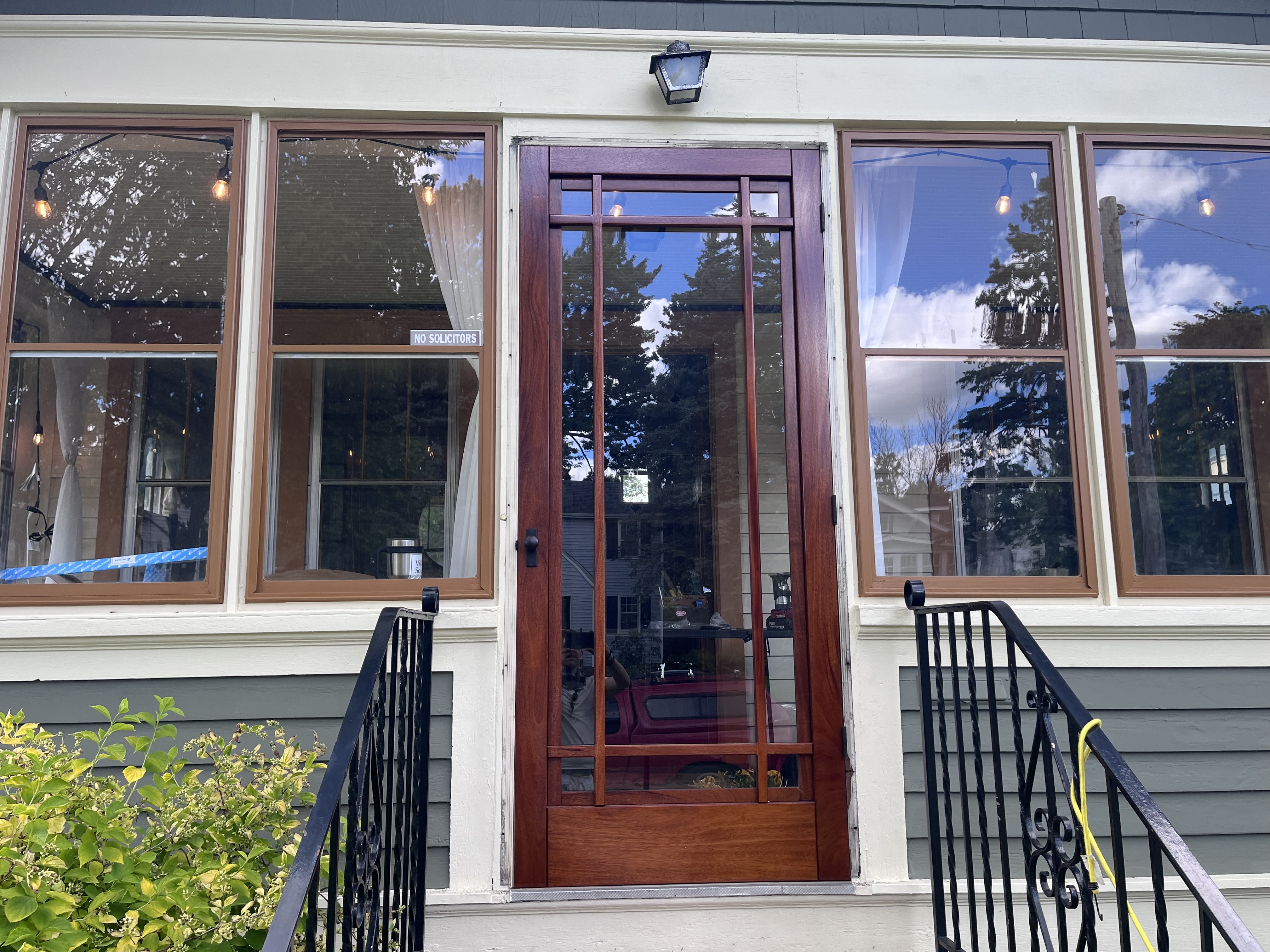 Mahogany front entry storm door installation, historic Saint Paul home - JAM Custom Carpentry